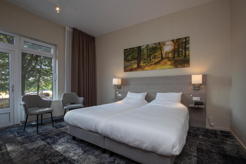 Postel nebo postele na pokoji v ubytování Fletcher Hotel-Restaurant Paasberg