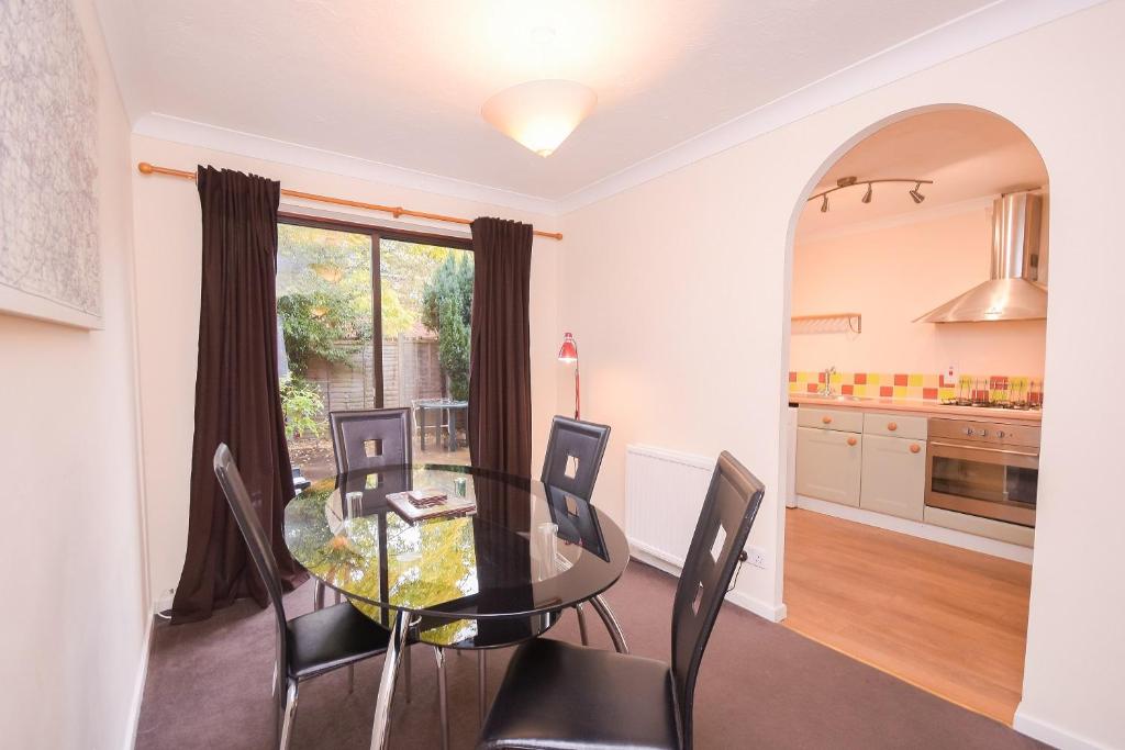a dining room with a glass table and chairs at Town or Country - Captains Place in Southampton