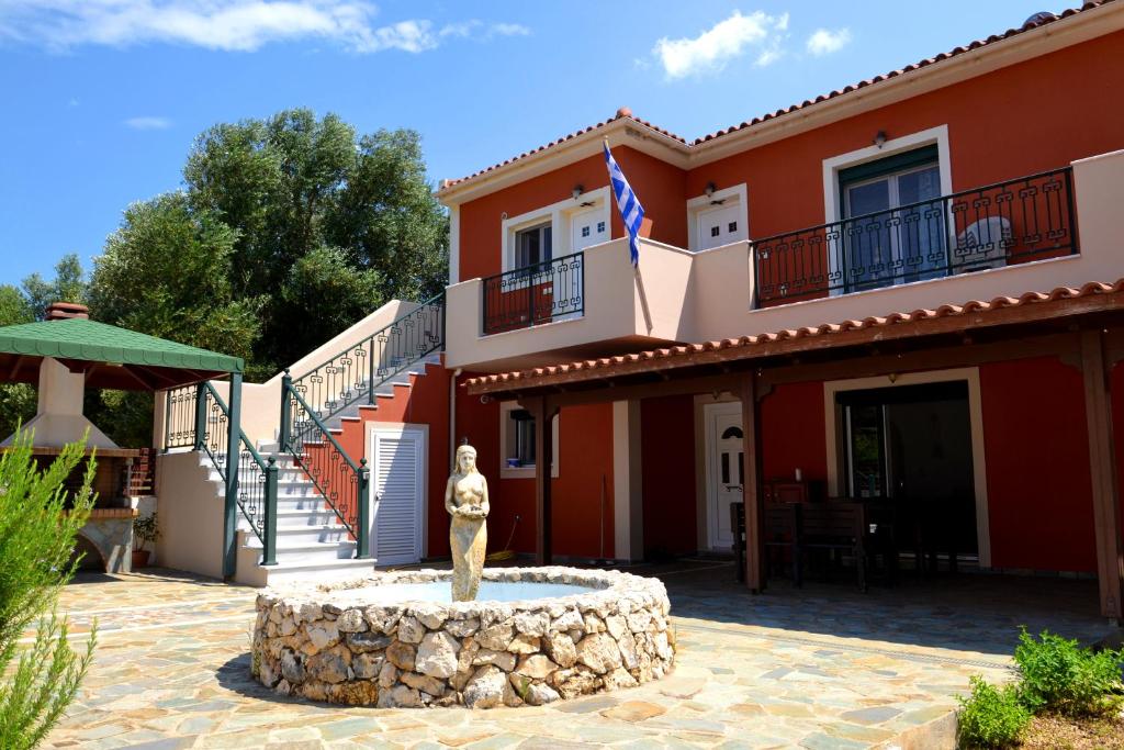 uma casa com uma estátua em frente em Spacious 1 bedroom apartment 2 km to Pessada beach em Dhorizáta