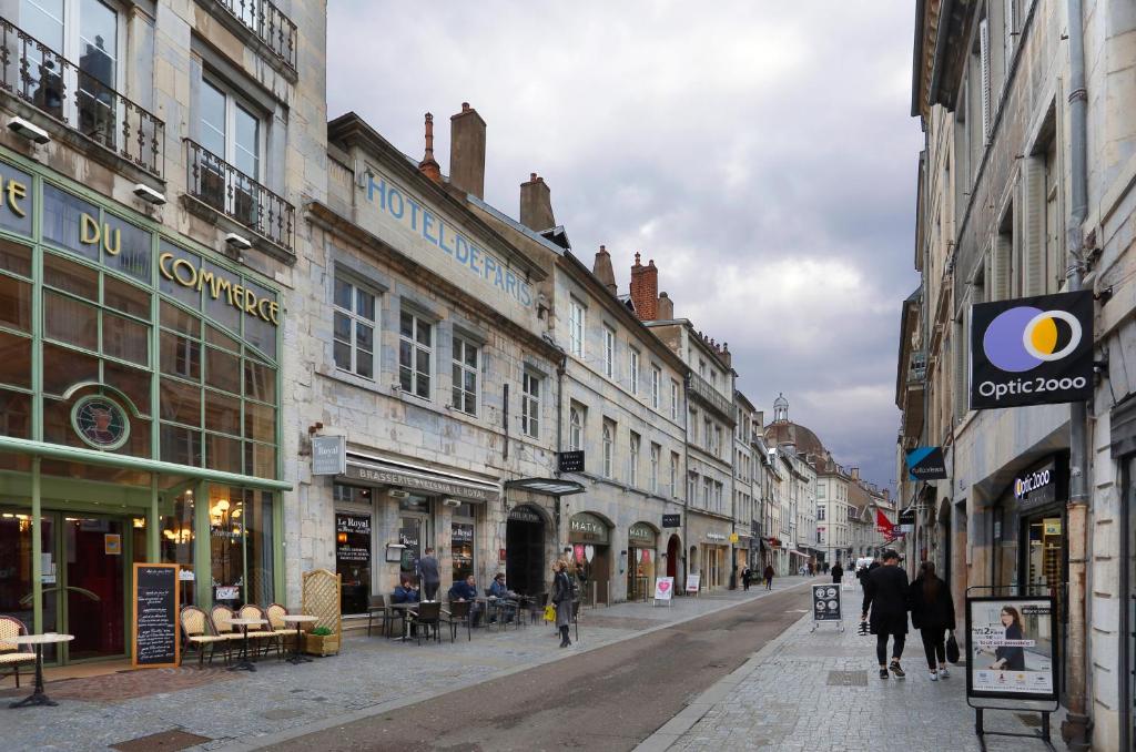 una calle de la ciudad con edificios y gente caminando por la calle en Hôtel de Paris, en Besançon