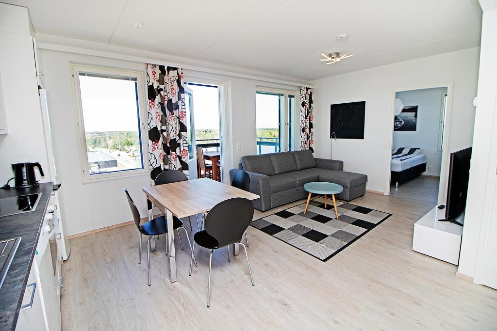 a living room with a table and a couch at Pro Apartments 1 in Vaasa