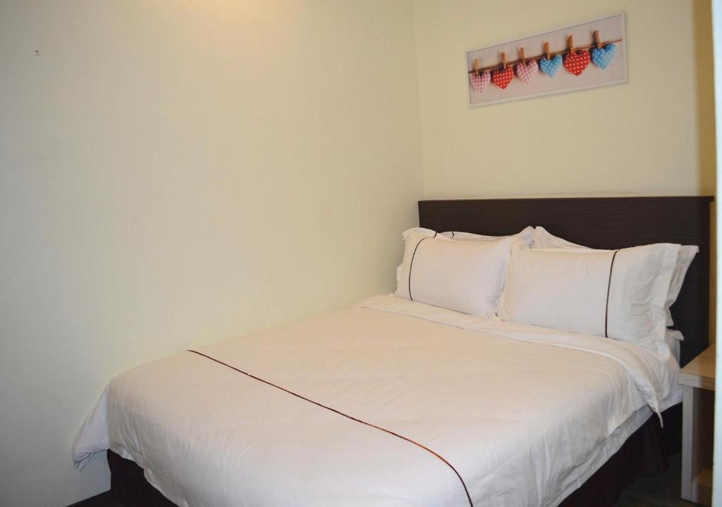Postel nebo postele na pokoji v ubytování Angsoka Hotel