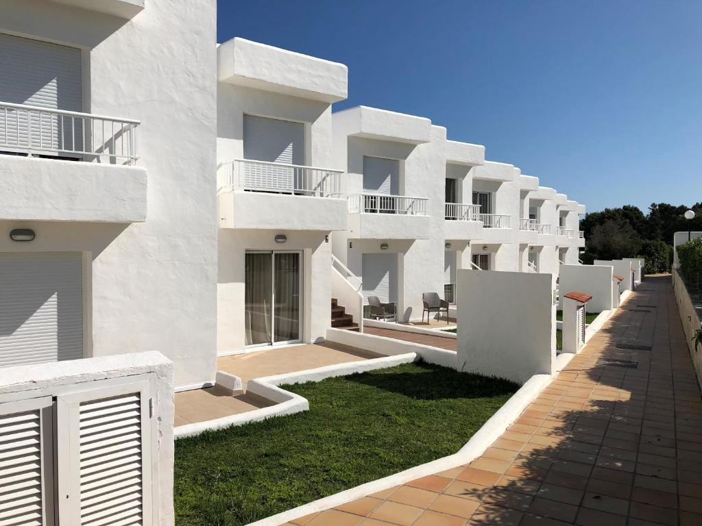 a row of white apartment buildings at Camelina Suites in San Antonio Bay