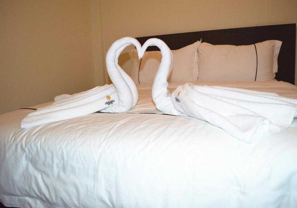 Postel nebo postele na pokoji v ubytování Angsoka Hotel