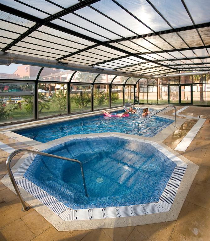 a large swimming pool with people in it at Hotel Clipper - EL DELFÍN VERDE RESORTS - Platja de Pals in Torroella de Montgrí