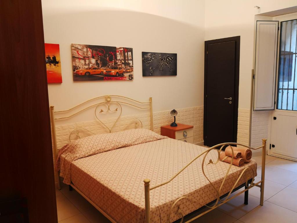 a bedroom with a bed and some pictures on the wall at centralcity in Reggio di Calabria