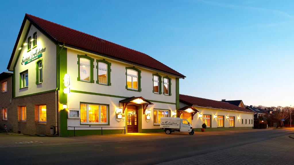 a white van parked in front of a building at Akzent Hotel Hubertus in Melle