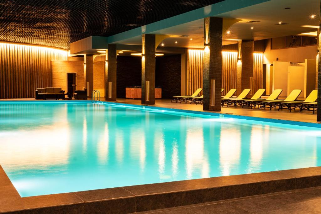 a large swimming pool in a hotel lobby at Garden Hotel and Spa in Cheboksary