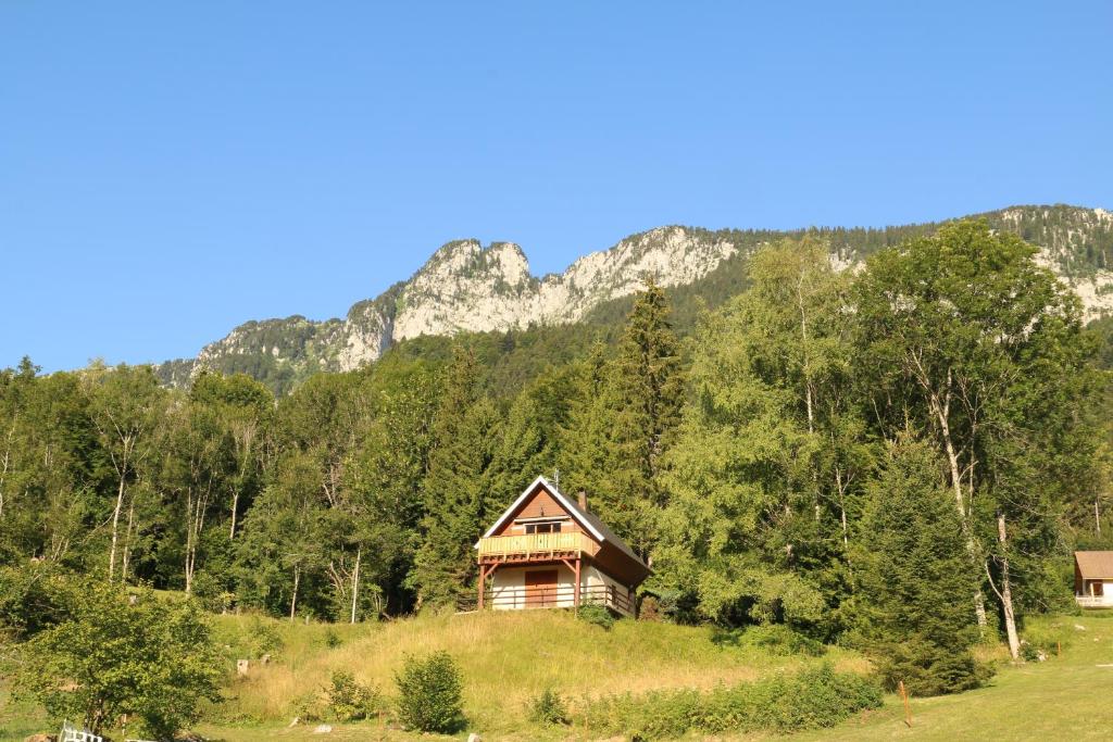 a house on a hill with a mountain in the background at Le Frenola in Saint-Pierre-dʼEntremont