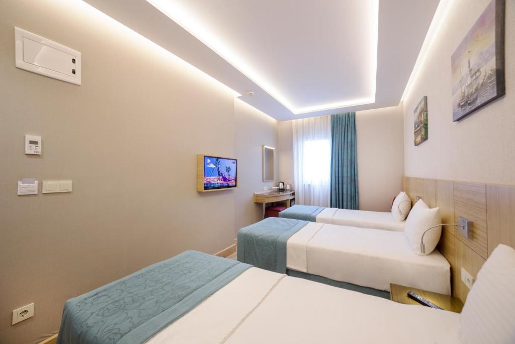 Postel nebo postele na pokoji v ubytování Meretto Hotel LALELİ