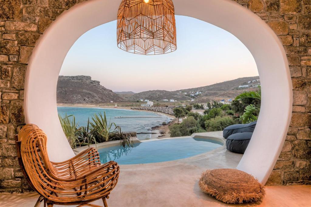 a view from a balcony of a house with a view of the ocean at Panormos Village in Mykonos
