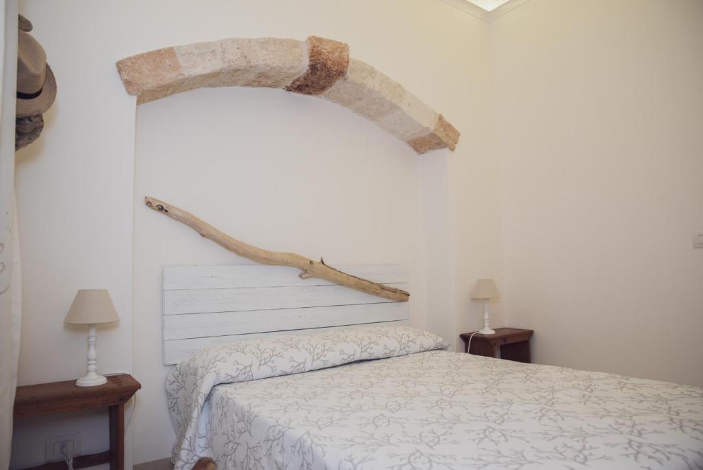Łóżko lub łóżka w pokoju w obiekcie CASA MELIO'