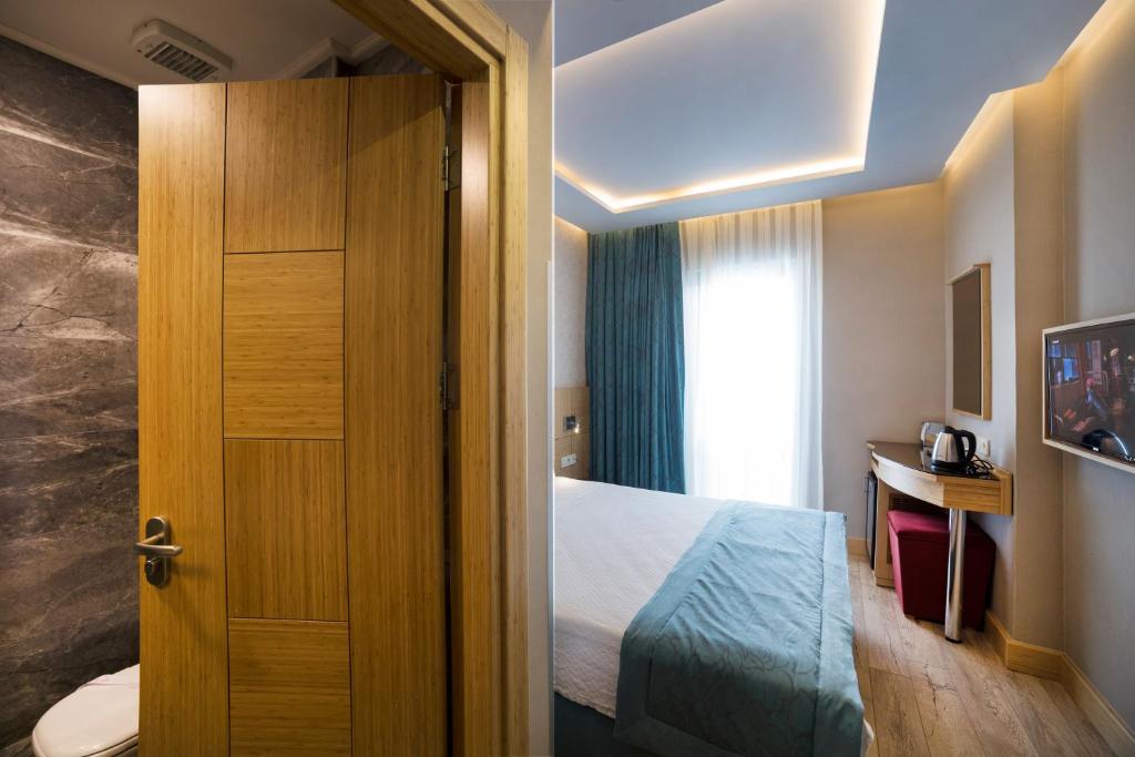 Postel nebo postele na pokoji v ubytování Meretto Hotel LALELİ
