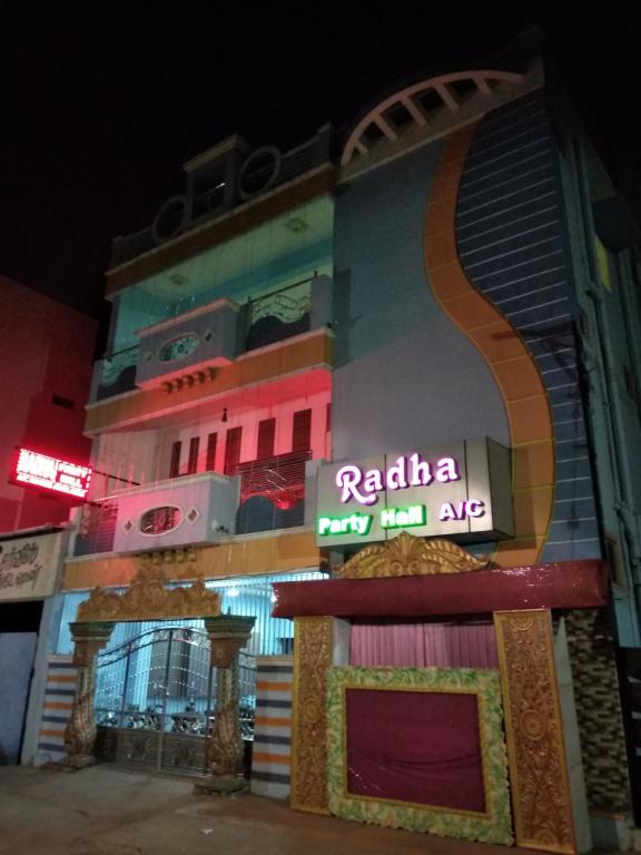a building with a sign on the side of it at Radha Party Hall in Kanchipuram