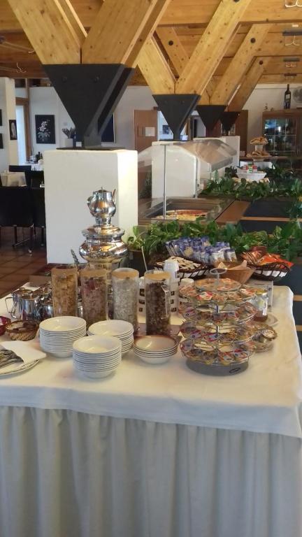 a white table with plates and food on it at I Grappoli in Sessa