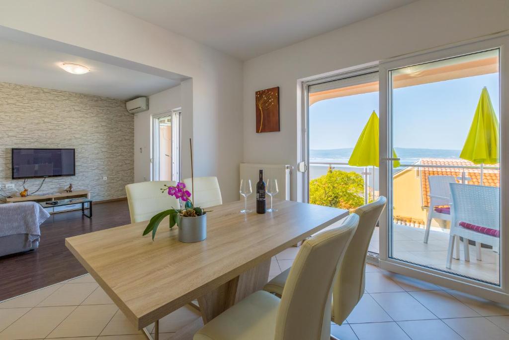 a dining room with a table and a view of the ocean at Apartmani Lucić in Crikvenica
