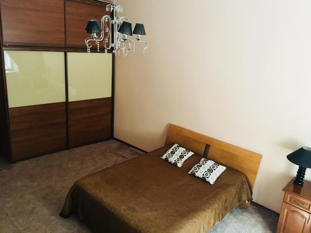 a bedroom with a bed with two pillows on it at Apartment in the city centre in Lviv