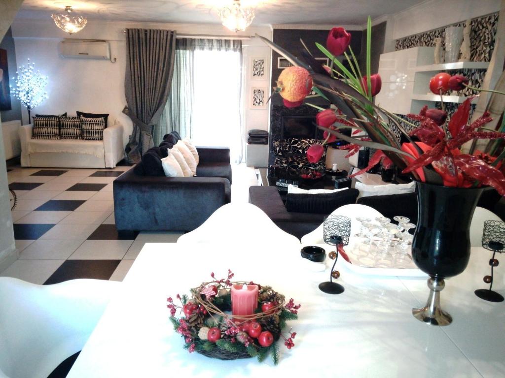 a living room with a table with a flower arrangement on it at Greek hospitality in Athens