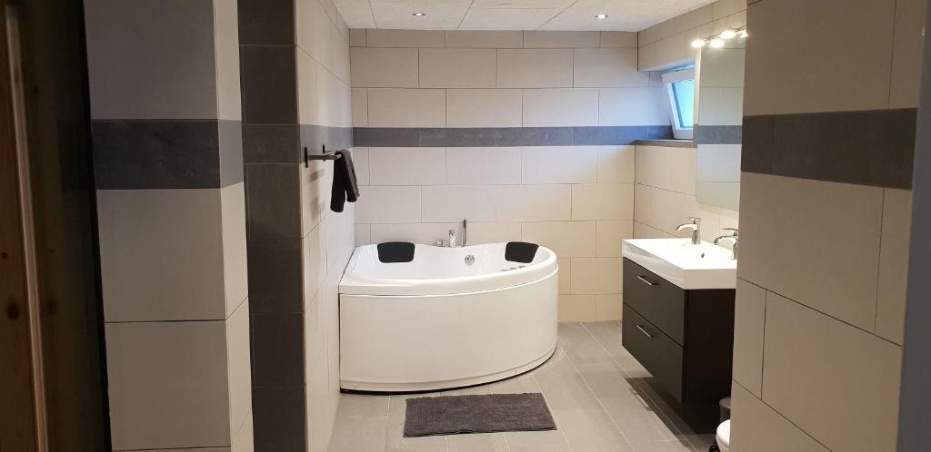 a bathroom with a white sink and a toilet at Surf And Family Sauna And Spa in Hvide Sande