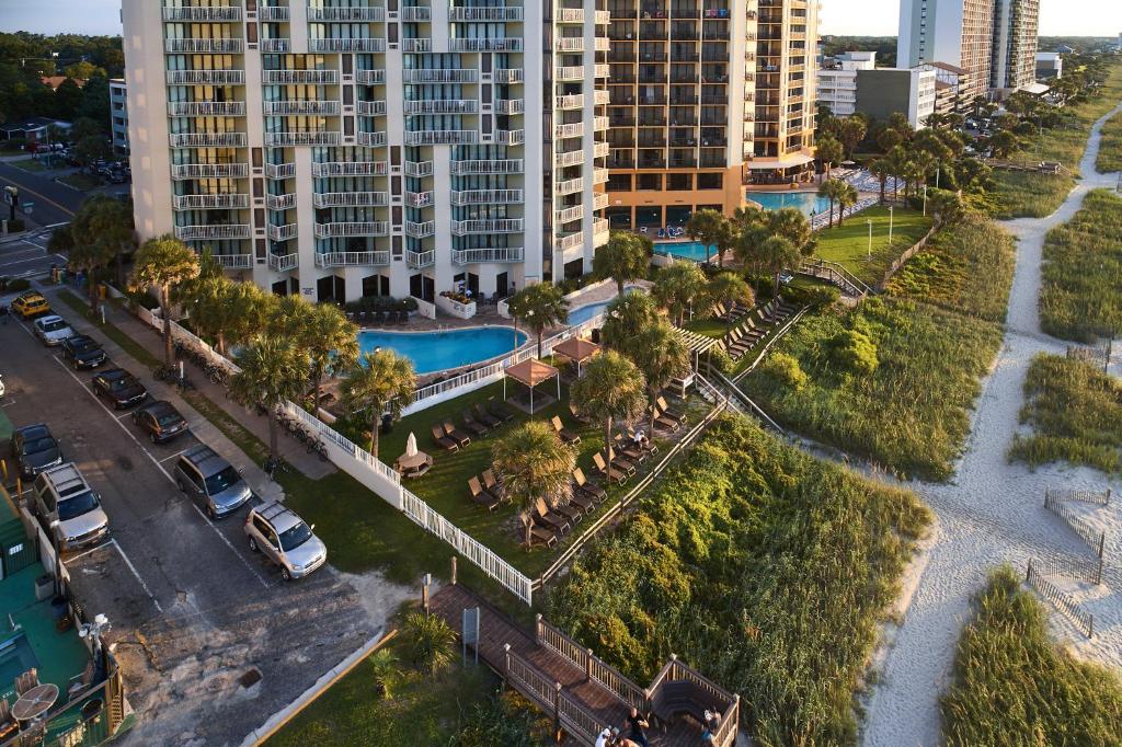 an aerial view of a city with a pool and buildings at The Strand - A Boutique Resort in Myrtle Beach