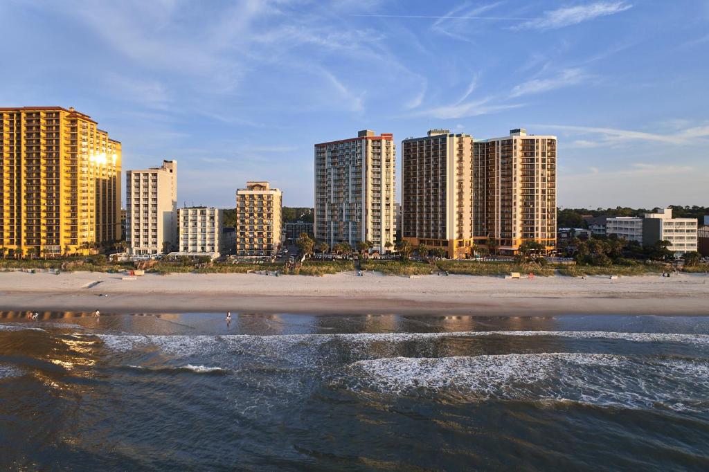 a view of a beach with tall buildings at The Strand - A Boutique Resort in Myrtle Beach