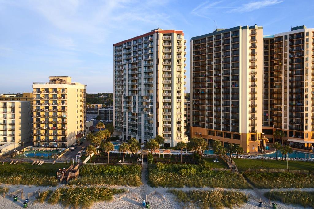 um grupo de edifícios altos em uma cidade em The Strand - A Boutique Resort em Myrtle Beach