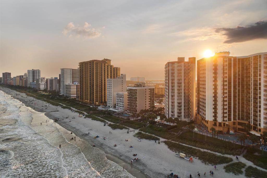 a view of a beach with buildings and the ocean at The Strand - A Boutique Resort in Myrtle Beach