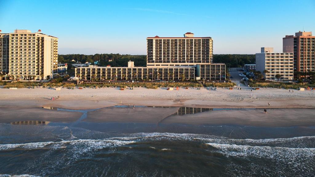 a view of a beach with buildings in the background at Compass Cove in Myrtle Beach