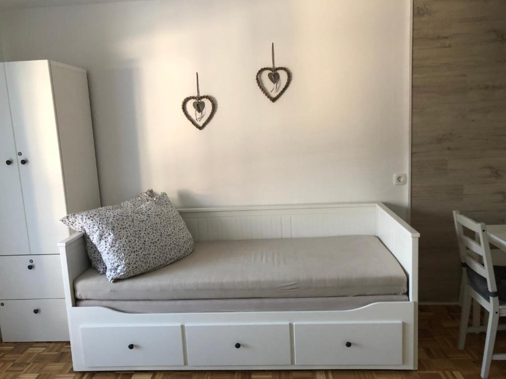 a room with a bench with two hearts on the wall at Apartma Vintage Bohinj in Bohinj