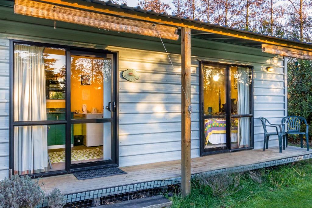 a screened in porch of a house with windows at Cavendish Farm in Kaiapoi