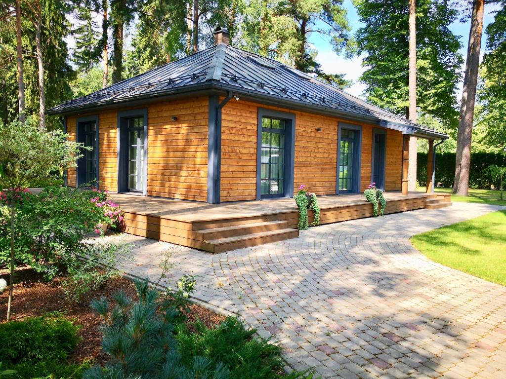 a small house with a porch and a patio at Villa Buta in Valmiera