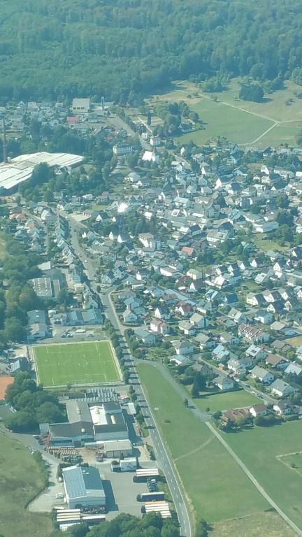 an aerial view of a city with houses and trees at Villa Jani b&amp;b in Breitscheid