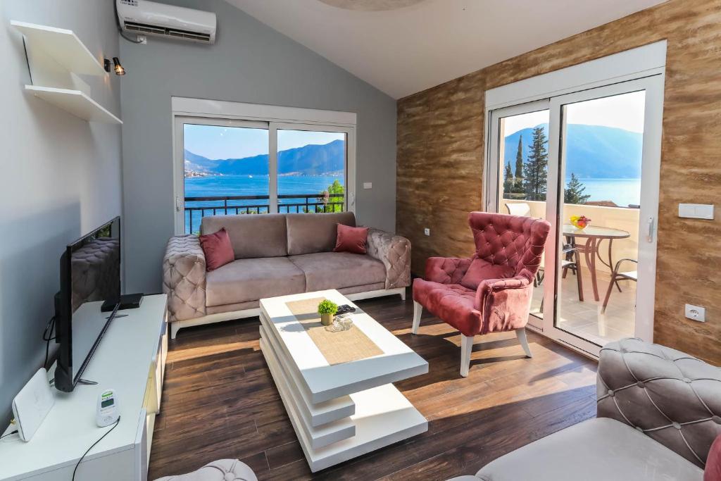 a living room with a couch and chairs and a table at JR Luxury Apartment in Kotor
