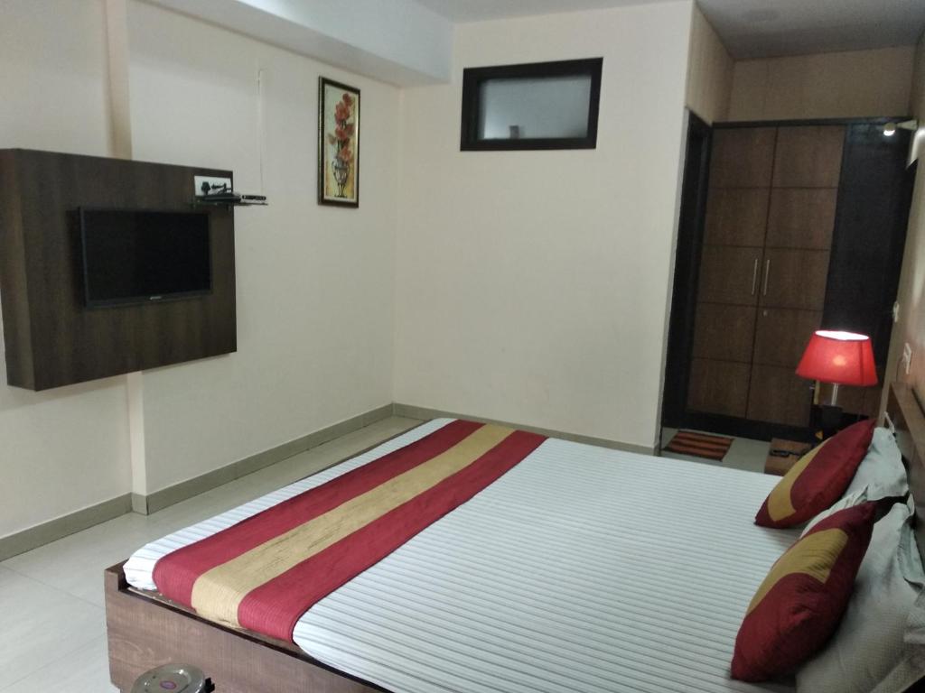 a bedroom with a bed and a television in it at Hotel Palace in Amritsar