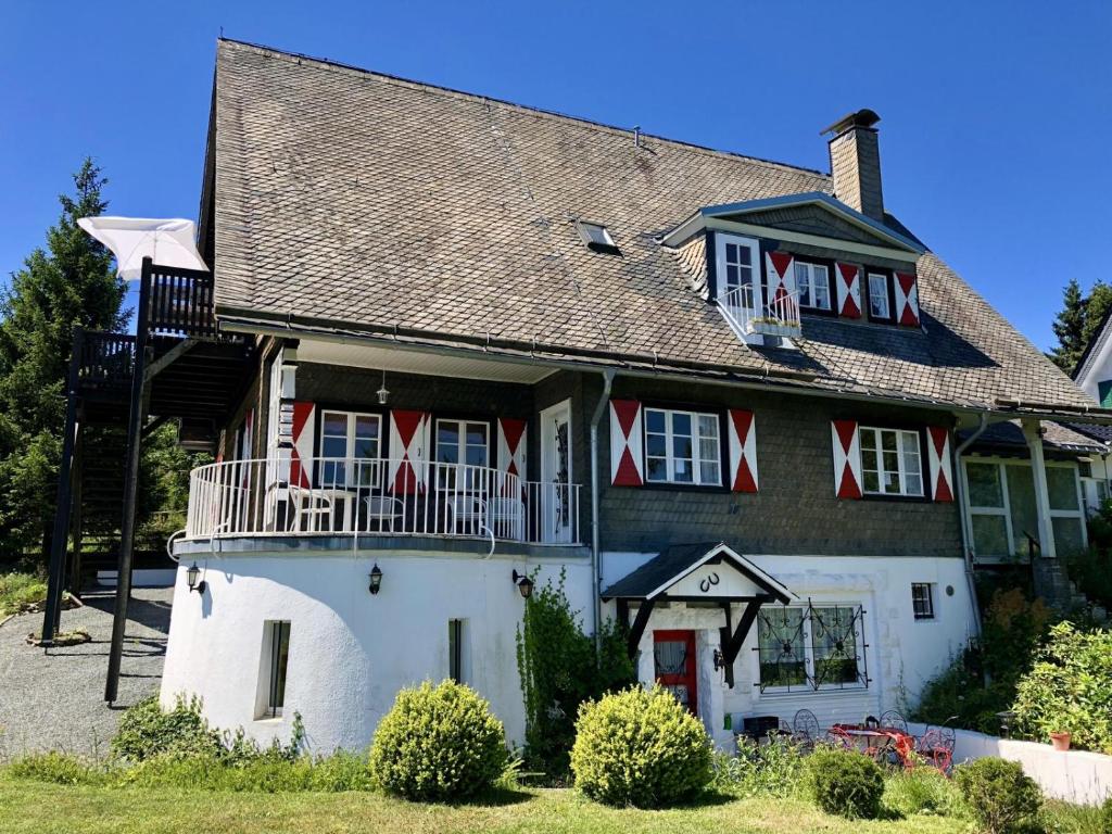 a large white house with a lighthouse at Haus Schneekappe (Winterberg) in Winterberg