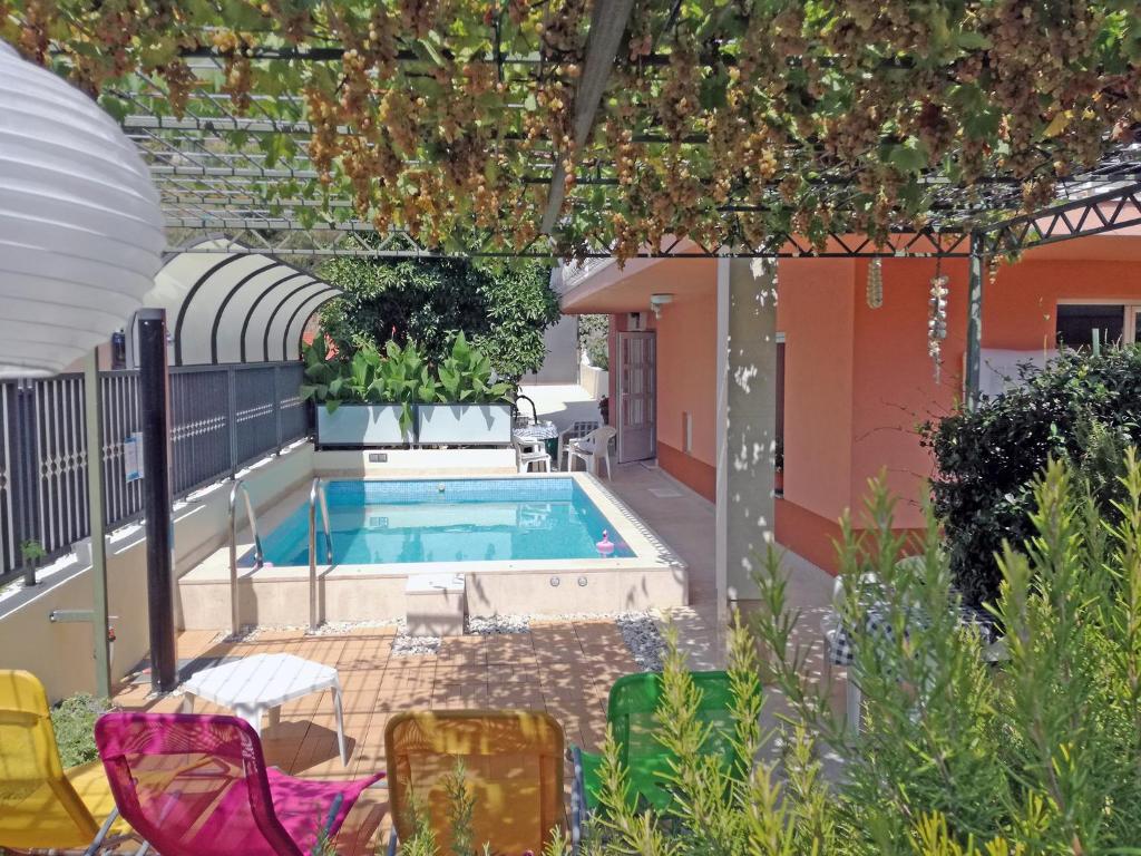 a swimming pool in the middle of a garden at Apartment Marjan Park in Split