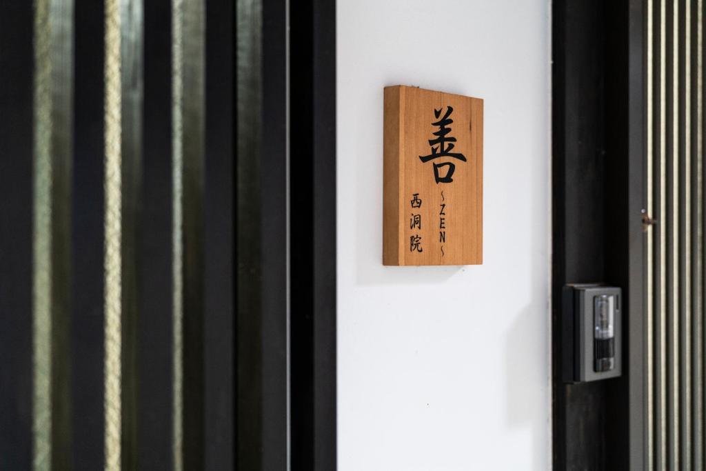 Una puerta con una señal en el costado. en Zen House, en Kioto