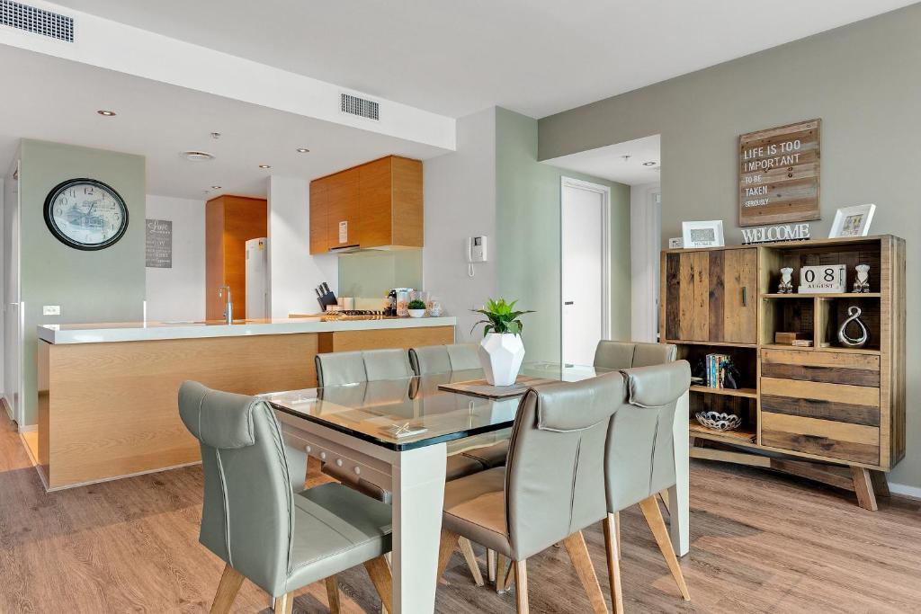 a kitchen and dining room with a table and chairs at Docklands Private Collection - NEWQUAY in Melbourne