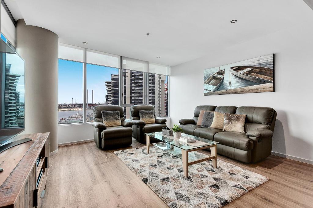 a living room with a couch and a table at Docklands Private Collection - NEWQUAY in Melbourne