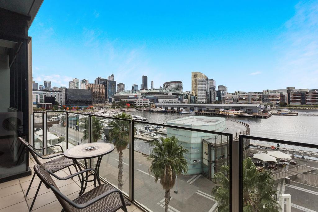 a balcony with a view of a river and a city at Docklands Private Collection - NEWQUAY in Melbourne