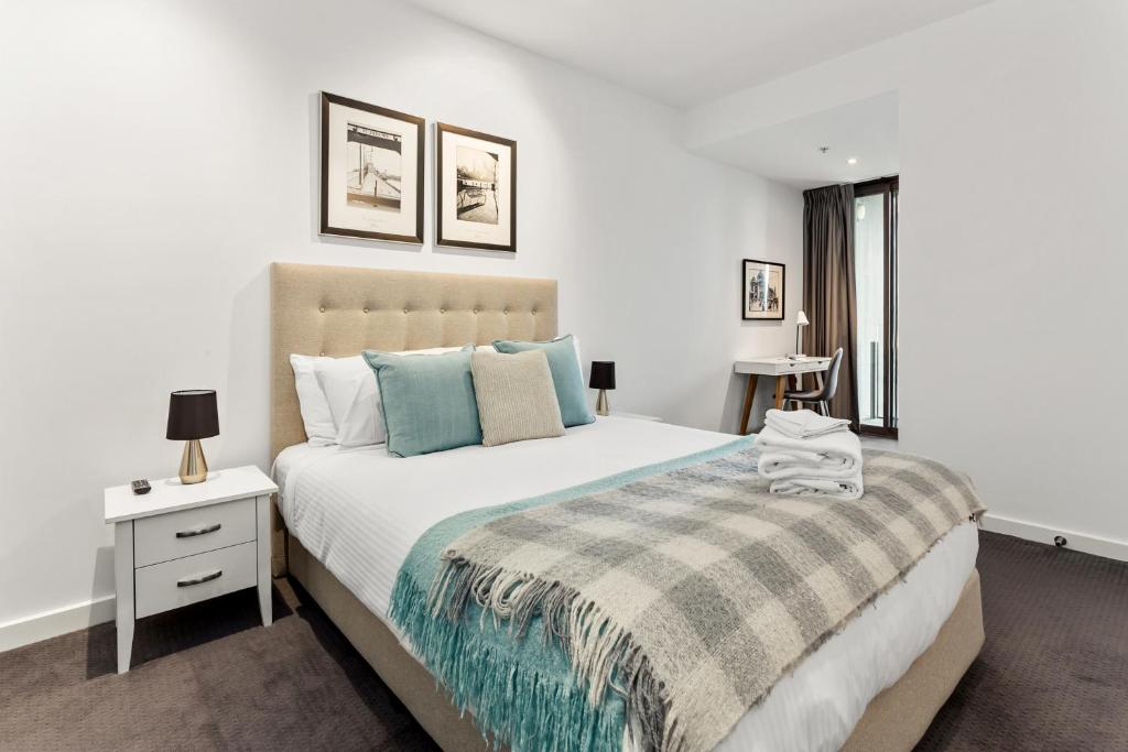 a bedroom with a large bed and a window at Docklands Private Collection - NEWQUAY in Melbourne