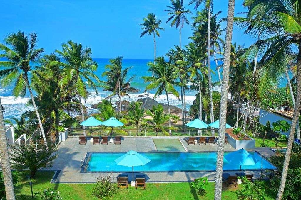 an aerial view of a resort with a pool and the ocean at R Degrees in Ambalangoda