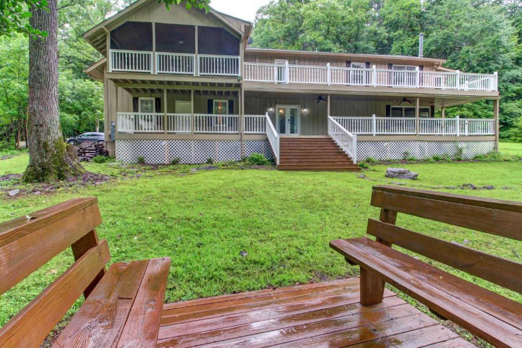 a home with two wooden benches in front of it at Laurel Lodge at Mountain Cove in Fort Smith