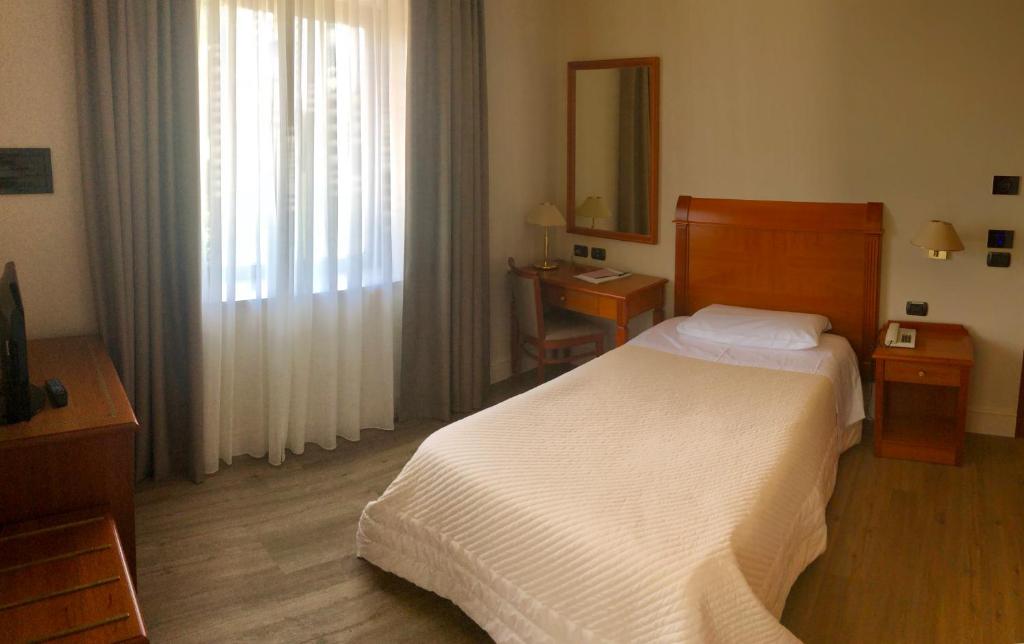 Postel nebo postele na pokoji v ubytování Hotel Touring
