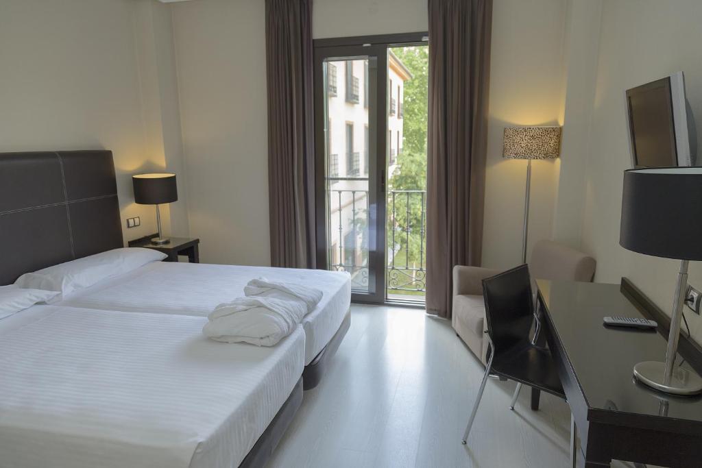 Posteľ alebo postele v izbe v ubytovaní Hotel Real Balneario Carlos III