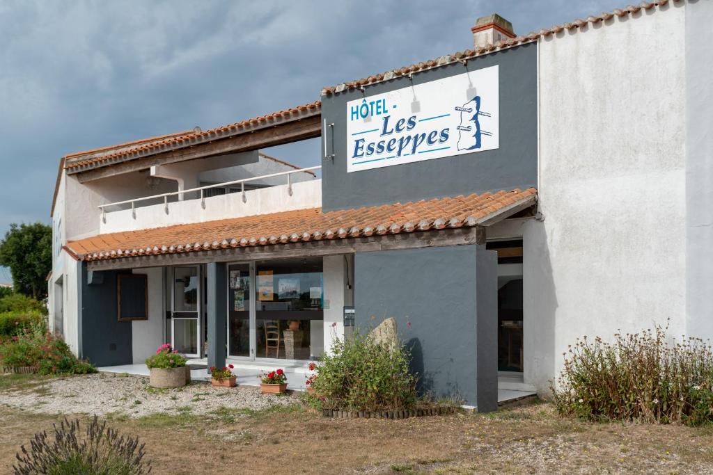 a building with a sign that reads hotel less reserves at Hotel Les Esseppes in LʼÉpine