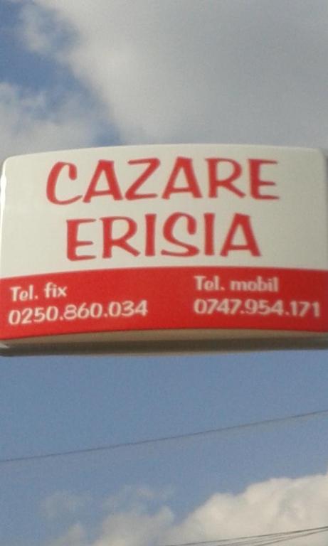 a sign for a car garage entity on the side of a building at Erisia in Horezu