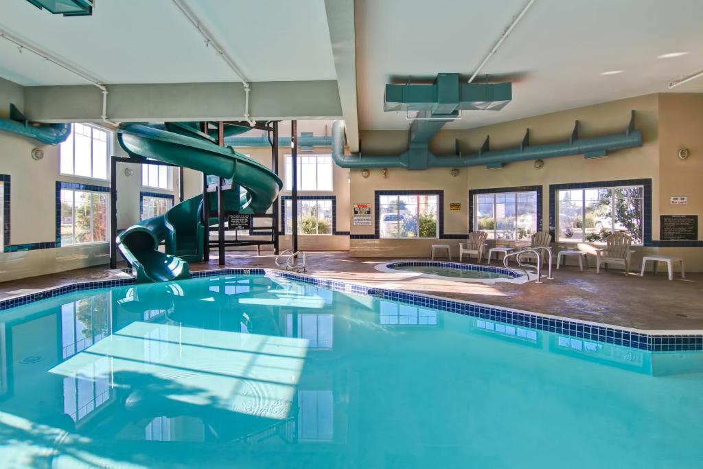 a swimming pool with a slide in a building at Canalta St.Paul in St. Paul