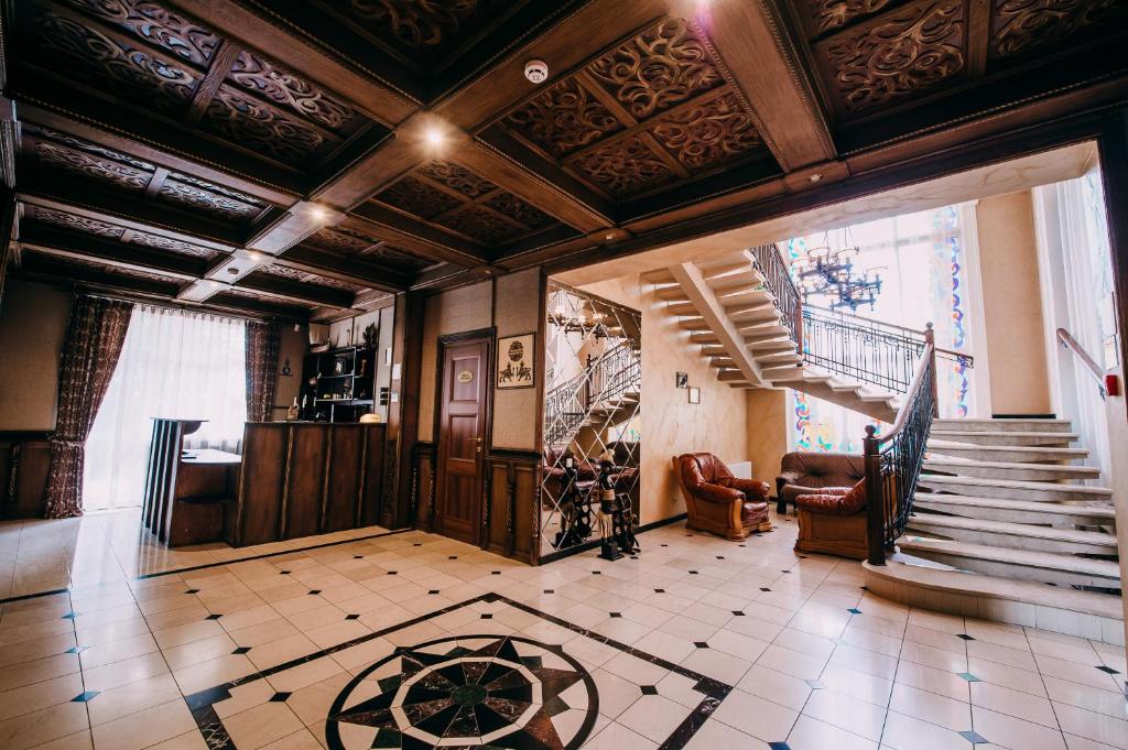 a living room with a staircase and a lobby at Urartu Hotel in Kharkiv