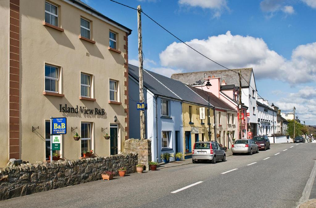 a city street with cars parked on the side of the street at Island View B&B in Roundstone